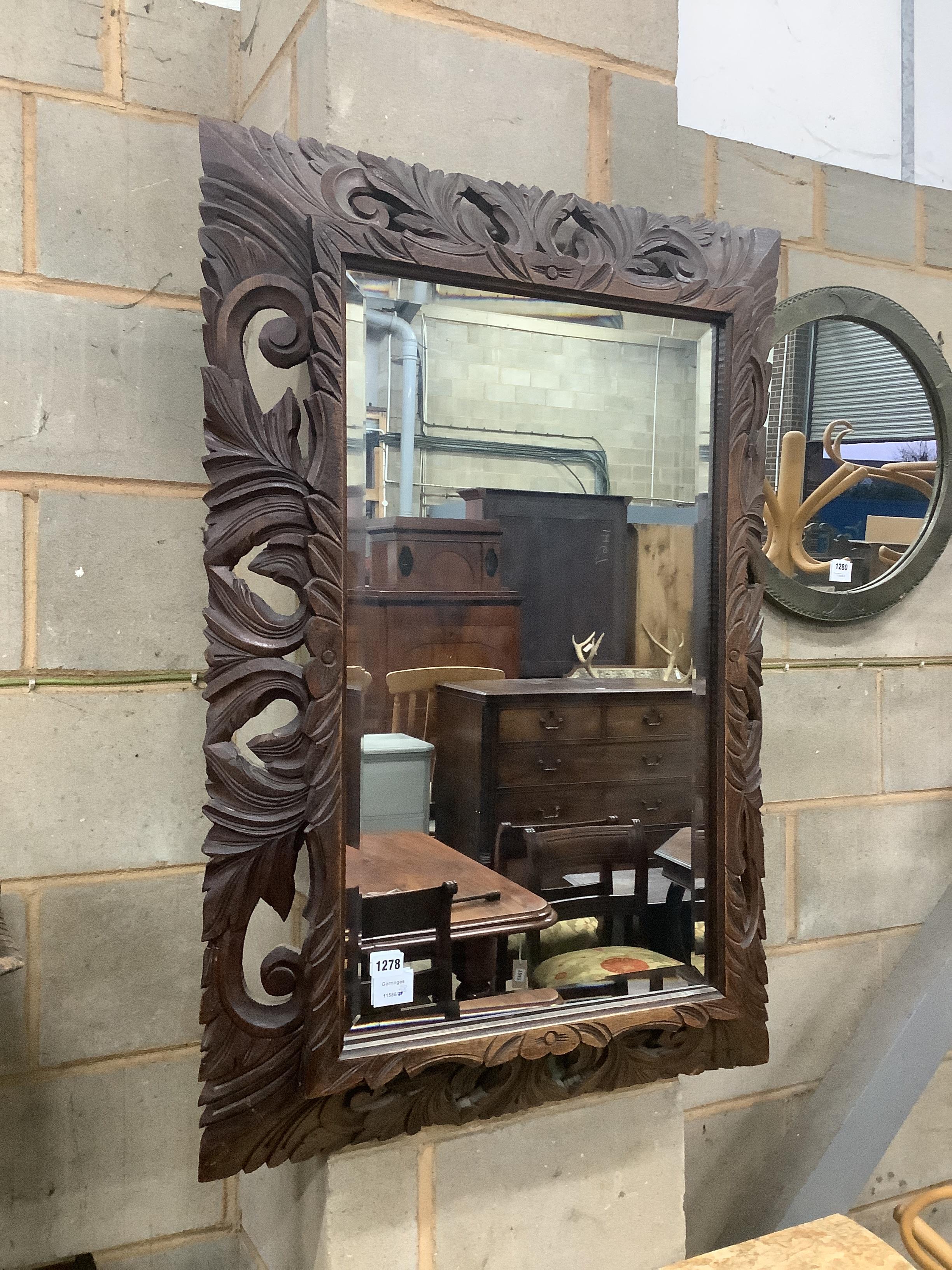 A late Victorian carved oak wall mirror